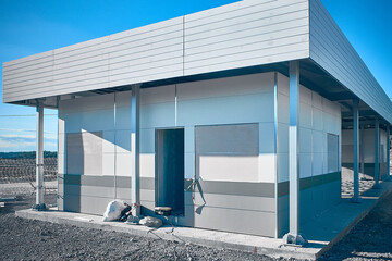 Mobile industrial building. Newly built single storey prefabricated industrial building. Prefabricated office container building at construction site 