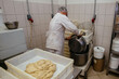 Baker puts dough into mixer in craft bakery