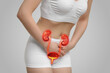 Woman suffering from cystitis on light background, closeup. Illustration of urinary system
