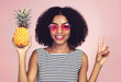 Peace sign, portrait and black woman with pineapple, studio or detox on pink background. Health, nutrition and gut digestion for weight loss and vitamins for female model, vegan and vitamin for fiber