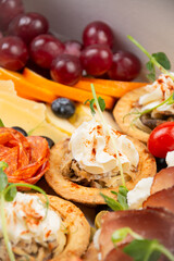 Wall Mural - Meat snacks with cream cheese, vegetables and salami close-up