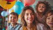 Joyful woman with three children surrounded by colorful balloons. Indoor group portrait with a celebration atmosphere. Family fun and happiness concept. Greeting card, family event invitation.