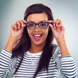 Portrait, woman and eyewear in studio, glasses and excited expression on gray background. Eyesight, spectacles or optometry for model, vision and stylish or trendy prescription lens as eye care