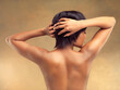 Beauty, back and black woman in studio, arms up for skincare on brown background. Dermatology, self care and hands for spa or salon treatment for female model, natural cosmetics or grooming for skin