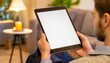 © Eggy - Tablet held by Man in a Living Room - Mockup for Application or Web Design - Template for Presentation of Graphic Design - Corporate Representation at Consumers