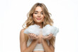 Young beautiful woman in a small top holding a cloud in her hands, on a white background