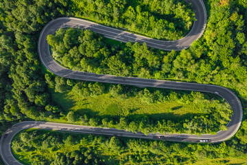 Wall Mural - Aerial summer view of a winding mountain road forming an S-shape