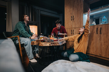 Poster - Group of young friends having a relaxed night with drinks and conversation at a house party