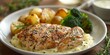 chicken cooked in a creamy yogurt sauce accompanied by broccoli and potatoes