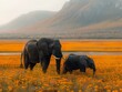 Tranquil Grandeur: Elephants Meandering Through Vibrant Fields
