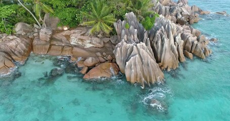 Poster - A beautiful blue ocean with a rocky shoreline. The water is calm and the sky is clear
