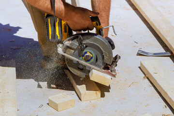 Wall Mural - Woodworking carpenter cutting wooden beams with handsaw