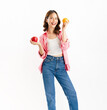 Charming joyful girl holding juicy orange and red apple on white background, vitamins for healthy skin.