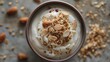 A minimalist shot of a bowl of Greek yogurt topped with granola and sliced almonds.