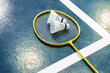 Yellow badminton racket and white badminton shuttlecock