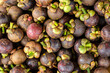Closeup of fresh ripe mangosteen fruits for sale in a market at Thailand