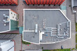 roof of a small office building with efficient ventilation system and air conditioning equipment. aerial top view.