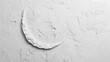 A textured white canvas with a single, deep indentation in the shape of a crescent moon.