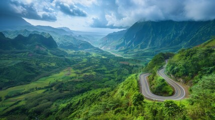 Wall Mural - A winding mountain road snaking through lush greenery, offering breathtaking views of the valley below and the peaks above.