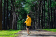 Trail runner is stretching for warm up outdoor in the pine forest dirt road for exercise and workout activities training for achieving healthy lifestyle and fitness usage