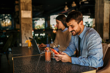 Wall Mural - Young startup economists during a meeting at a coffee shop