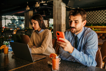 Wall Mural - Young startup economists during a meeting at a coffee shop