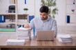 © Elnur - Young male employee and too much work in the office