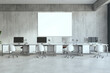 Contemporary coworking office interior with daylight and empty white mock up banner on concrete wall. 3D Rendering.