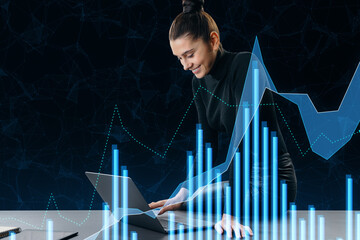 Poster - Attractive happy young businesswoman sitting on desk and using growing forex chart on blurry office interior background. Trade, finance and stock concept. Double exposure.