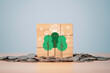 Drawing of tree and CO2 reduction icon print screen on wooden block cube and heap of coins for decrease CO2 , carbon footprint and carbon credit to limit global warming from climate change concept.