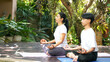 Lifestyle woman and teenage student yoga exercise and pose for healthy life. Two people pose balance body vital zen meditation for workout nature garden at home.Â  Healthy and sport activity Concept
