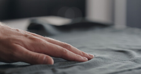 man touching cyan cotton clothes closeup