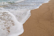 Sandy beach with small waves background