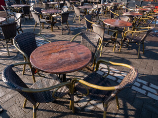 Outdoor restaurant background, empty brown chairs and tables