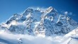 Snowcovered mountain peaks with a clear blue sky in the background for a crisp winter wallpaper