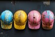 Helmets. Old Construction Hard Hats in Blue, Yellow, and Pink for Workwear Protection