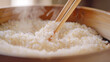 A bowl of rice with chopsticks in it