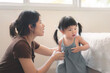 Asian mother disciplining her child, Asian girl kid being defiant with mom, Terrible two concept.