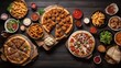 Buffet table scene of take out or delivery foods. Pizza, hamburgers, fried chicken and sides. Above view on a dark wood background.
