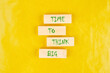 Business and Time to think big concept. Time to think big symbol on wooden blocks on a yellow background