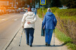Senior women walks with cane along the city streets, strolling together. Companionship in aging. Elder couple walking together with cane for stability and support. Old women with walking sticks