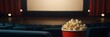 Blank screen at the movie theater and woman eating popcorn, movies and entertainment concept, copy space