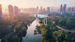 © YOGI C - drone technology in action amidst towering buildings and a serene river, with a white airplane soar