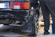 rear stop light of a black car in foam at a car wash close-up. A black modern car is washed with a pressure washer. cleaning, foam sprayed on the car.