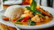 A close-up of a plate of colorful and aromatic Thai curry served with steamed rice, representing Thai culinary delights.