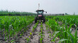 © YOGI C - smart farming solutions for the future a black tractor plows through a lush green field under a cle