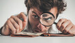Angry young man looking through a magnifying glass at empty wallet on white background