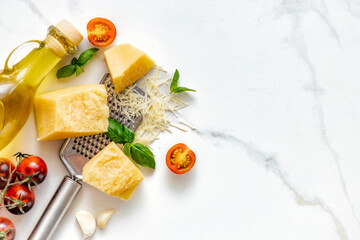 Canvas Print - Italian food cooking ingredients background on white stone table with copy space top view. Healthy eating