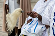 Ethiopian man holding a horse hair fly whisk during prayers in Jerusalem, Israel.