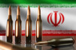 Machine gun cartridges are nearby. Iran flag. Iranian-made ammunition. Large caliber cartridges on desk. Iran military industry concept. Ammunition for weapons. Ammunition for Iran soldiers. 3d image